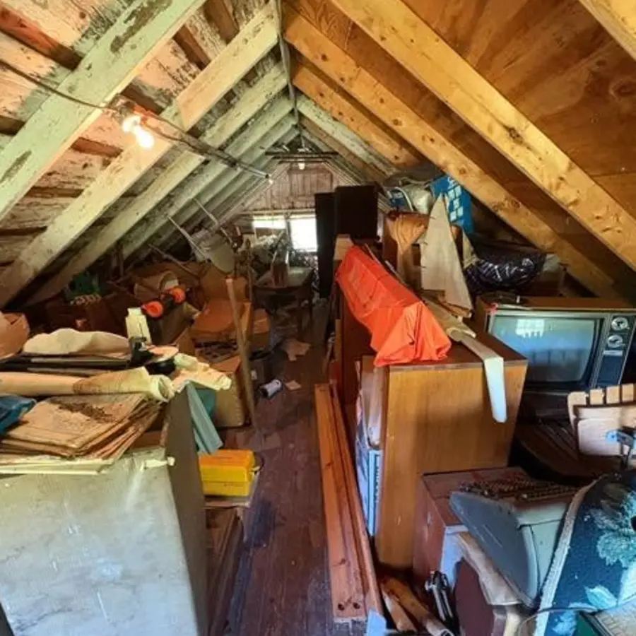 Large attic filled with mixed items before cleanout