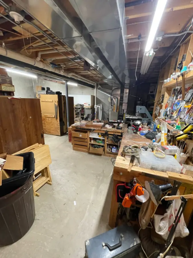 Cluttered basement workshop before cleanout