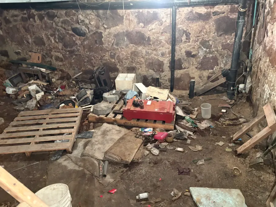 Old stone cellar with debris before cleanout