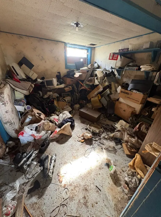 Basement room filled with household items before cleanout