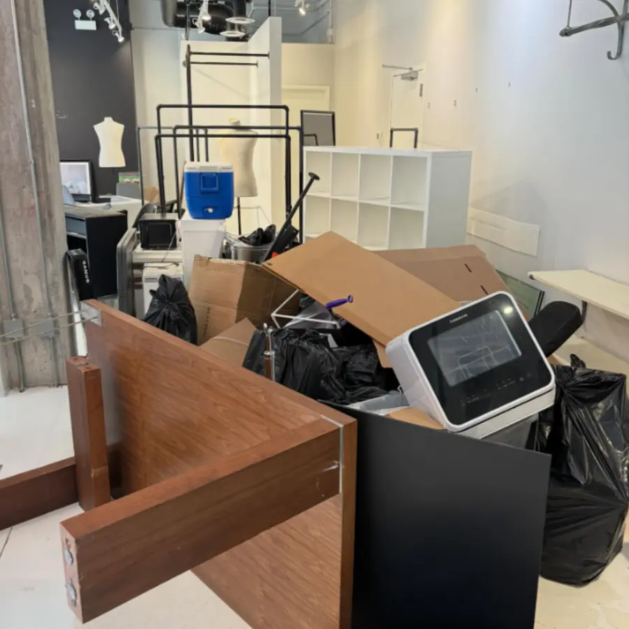 Boutique filled with fixtures and equipment before cleanout