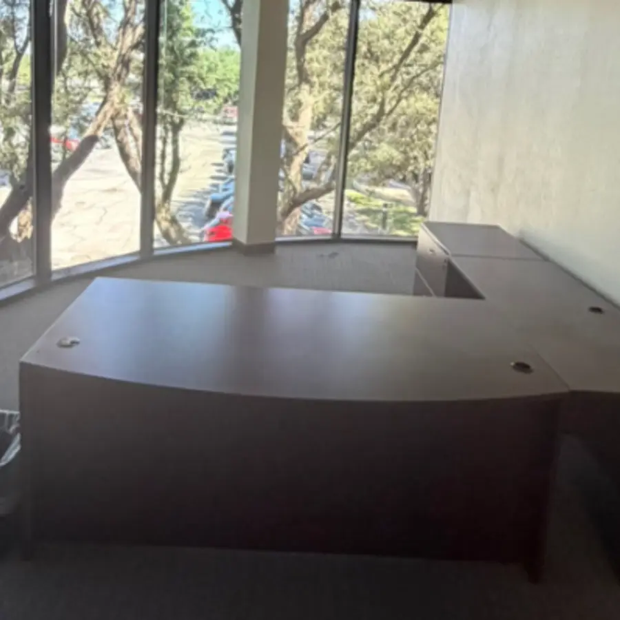 Large office desk before furniture removal