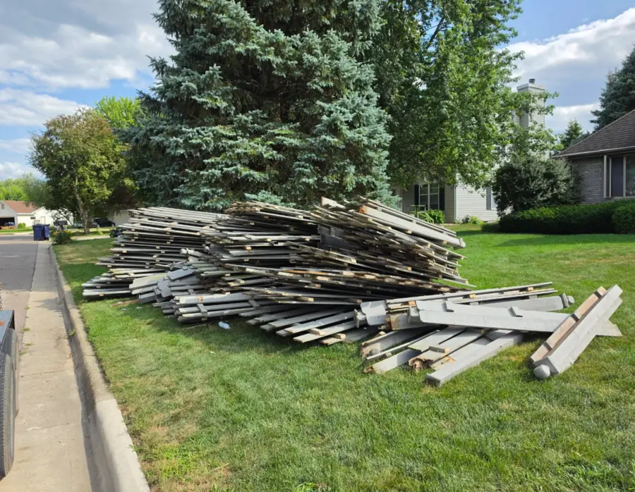Large pile of dismantled deck boards before haul-away