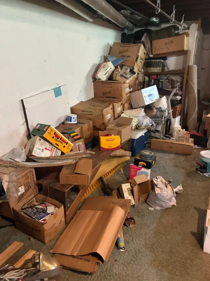 Basement filled with boxes and household belongings before estate cleanout