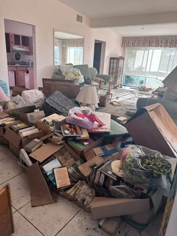 Large estate cleanout with furniture, boxes and household items ready for removal