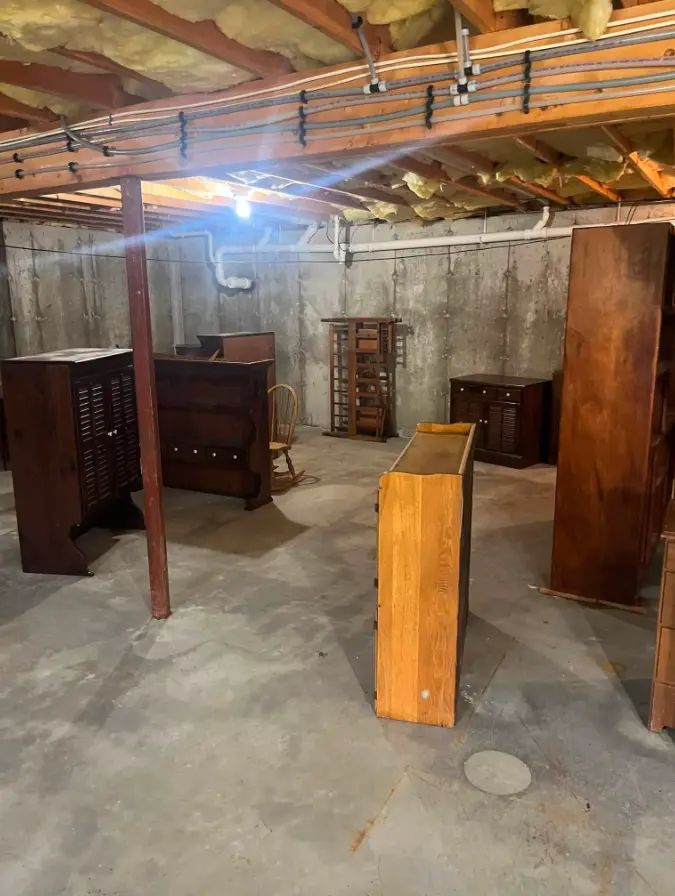 Basement with unwanted wooden furniture before removal