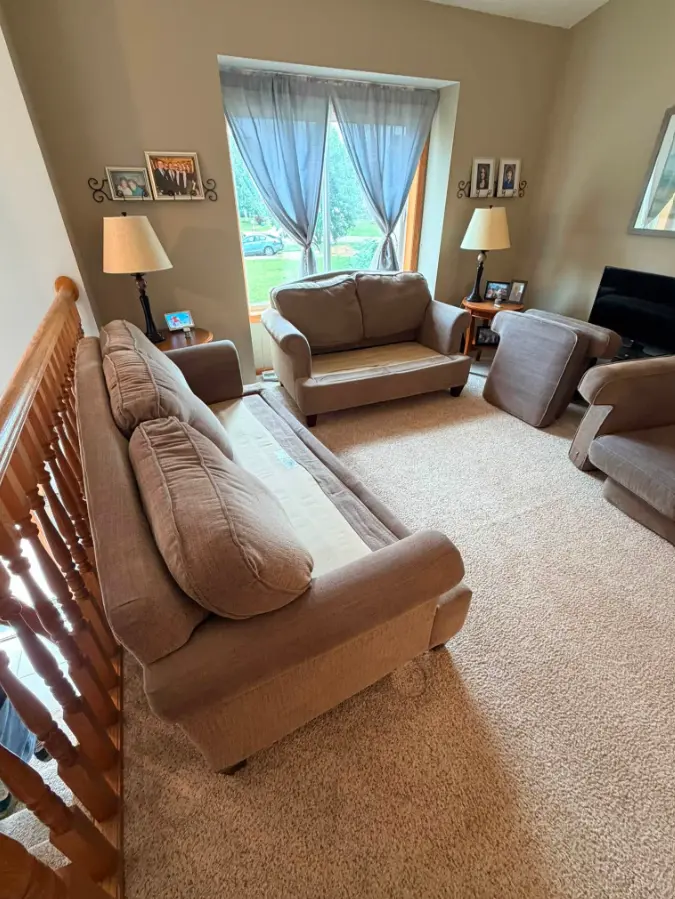 Living room with sofas and chairs before furniture removal