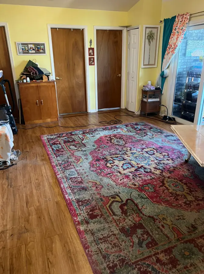 Living room cleared after sectional sofa removal