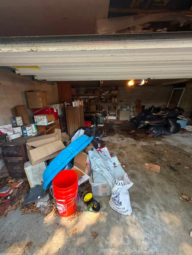 Garage with boxes, bags and household items before cleanout