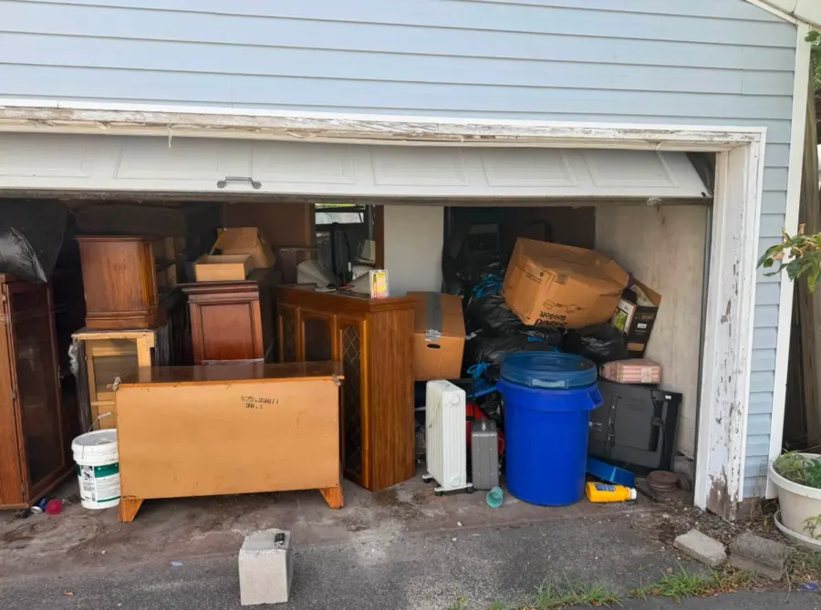 Garage packed with furniture, bags and boxes before cleanout