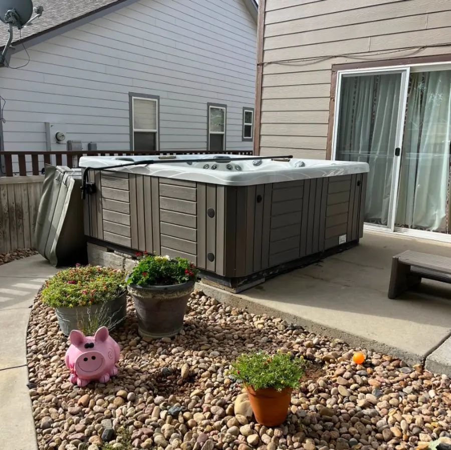 Hot tub on a residential concrete patio before removal