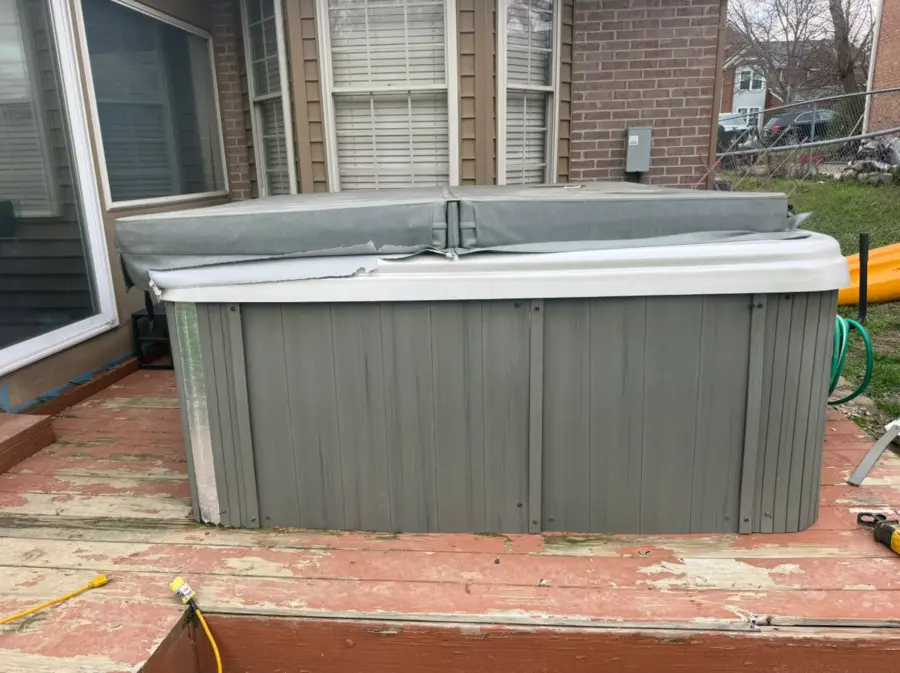 Hot tub on a residential wood deck before removal