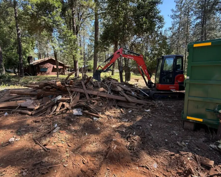 Debris being cleared after small outbuilding demolition