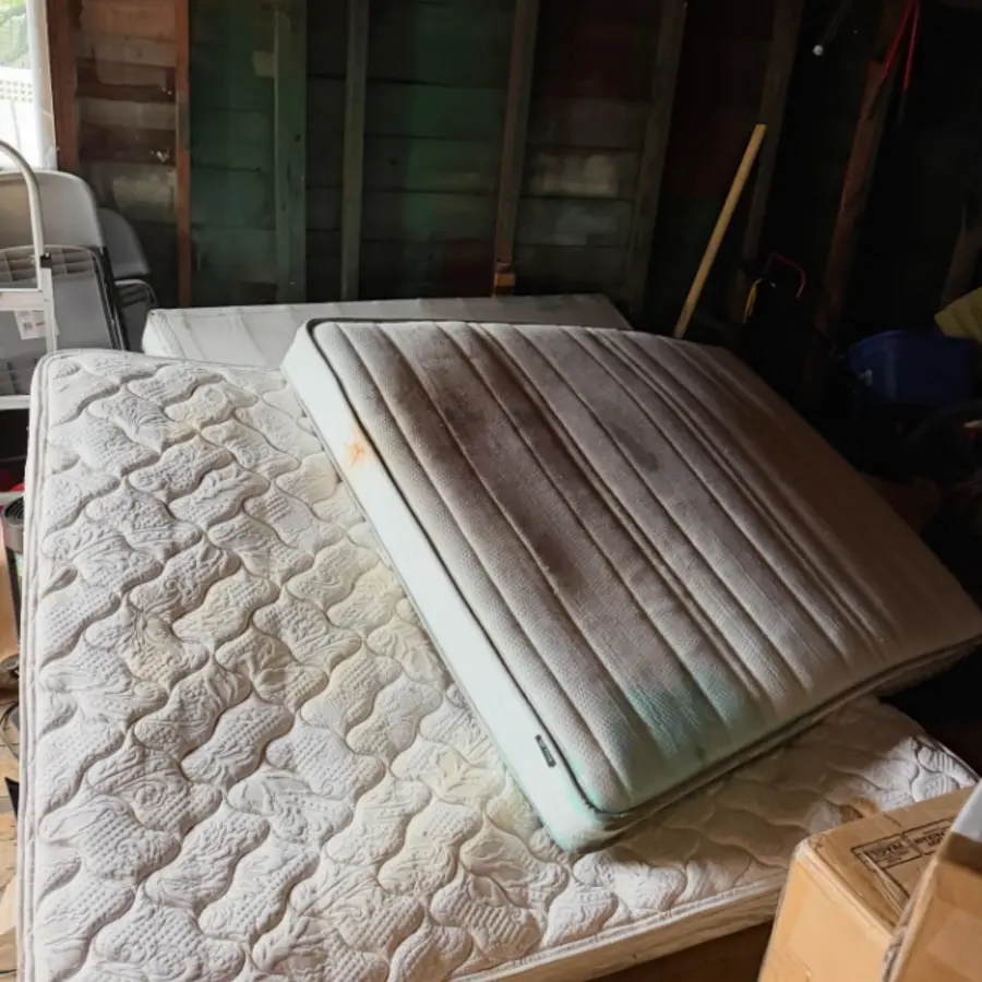 Mattresses in a garage before pickup