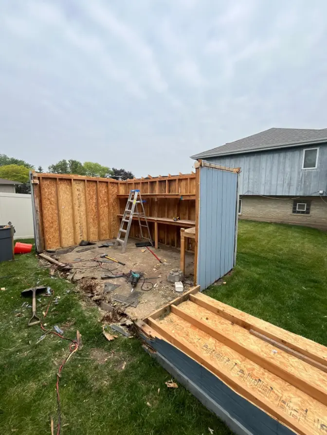 Blue wooden workshop shed during dismantling