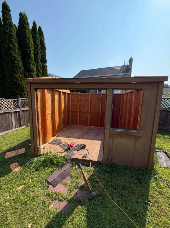 Brown backyard wood shed before removal
