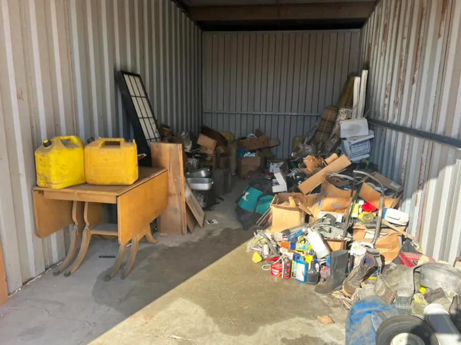 Large storage unit filled with mixed items before cleanout