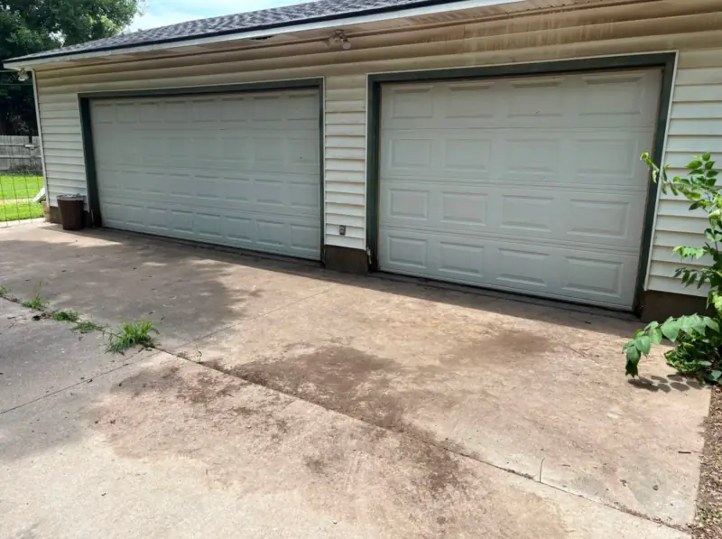 Garage driveway cleared after the branch pile was removed